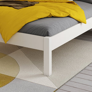 close-up-white-double-bed-wooden-legs