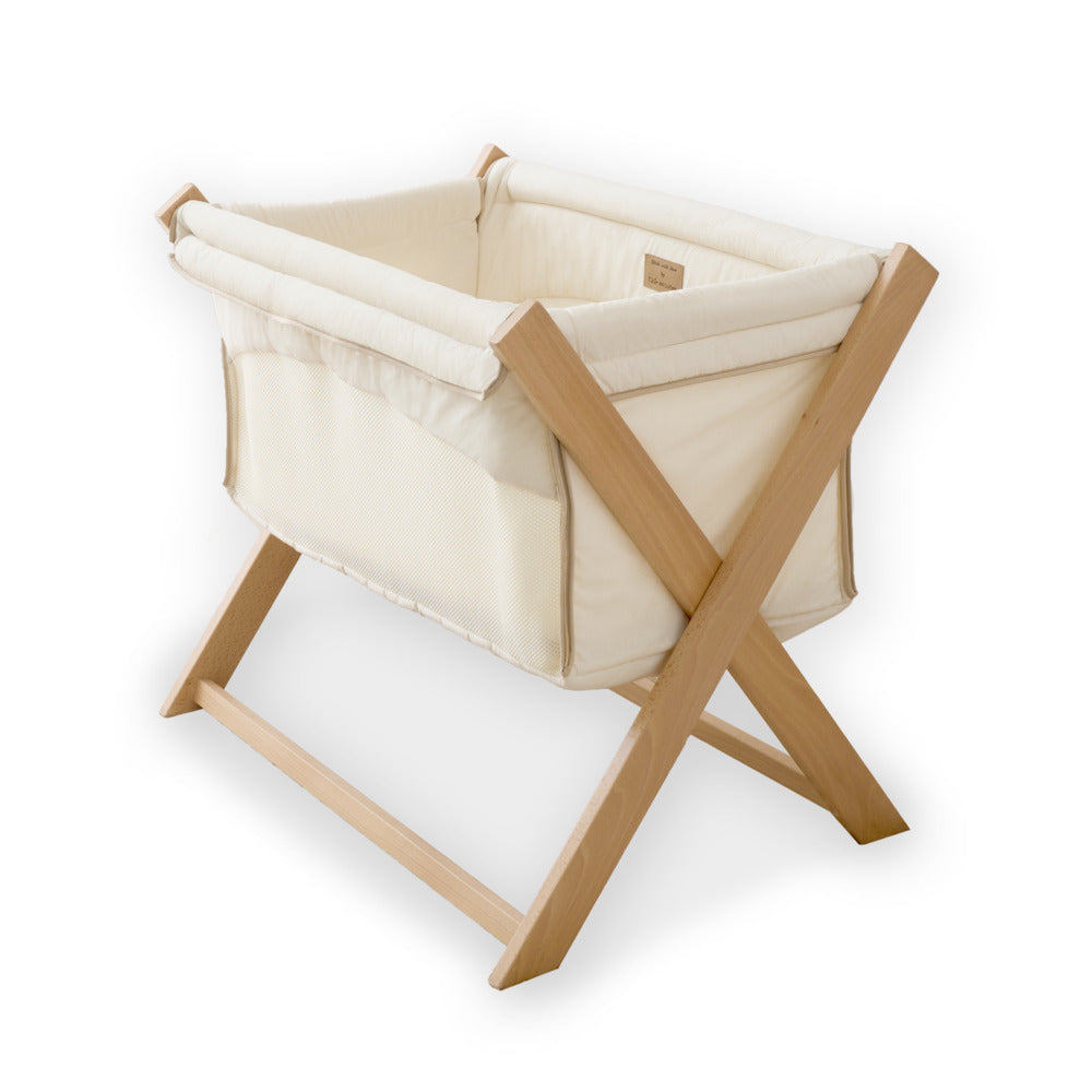 Clair de Lune Organic Folding Crib with a stand and white background